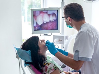 Dentist examining patient's teeth