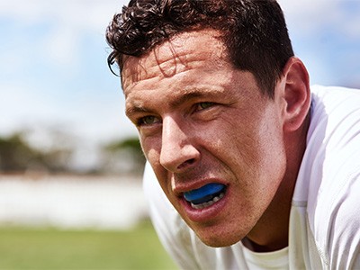 Closeup of man wearing blue mouthguard