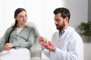 a patient speaking with their dentist about dental implants